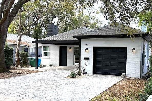 A white brick house with a black garage door and a paved driveway — 1741 LYNDALE BOULEVARD, MAITLAND, FL
