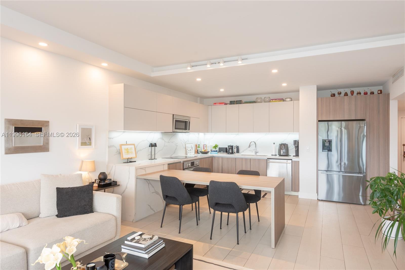 A modern kitchen with light wood cabinets and a marble-topped dining island — 151 Crandon Blvd # 241, Key Biscayne FL 33149, KEY BISCAYNE, FL