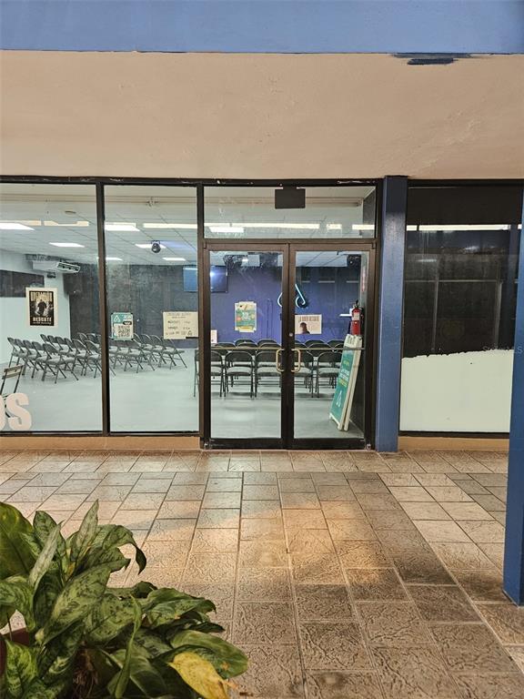 A storefront entrance features glass double doors leading into a room with rows of chairs — 100 SECTOR LA CUESTA, LOS JOBOS, HUMACAO, PR