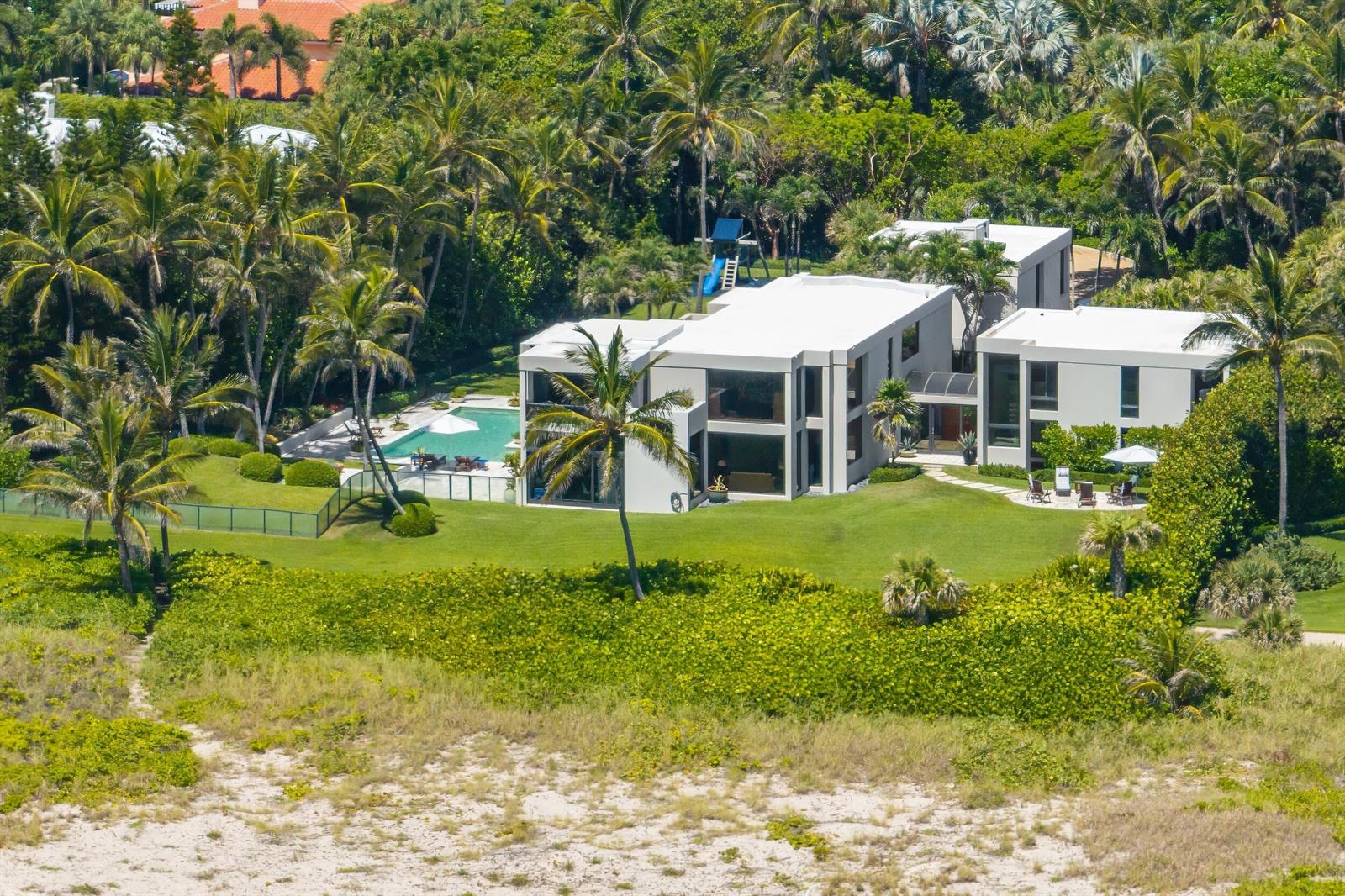 An aerial view of a modern white house with a pool surrounded by palm trees — 1446 N Ocean Boulevard, Palm Beach FL 33480, PALM BEACH, FL