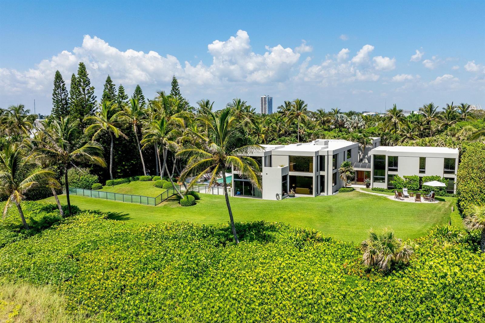 An aerial view of a modern white house surrounded by palm trees and green lawns — 1446 N Ocean Boulevard, Palm Beach FL 33480, PALM BEACH, FL
