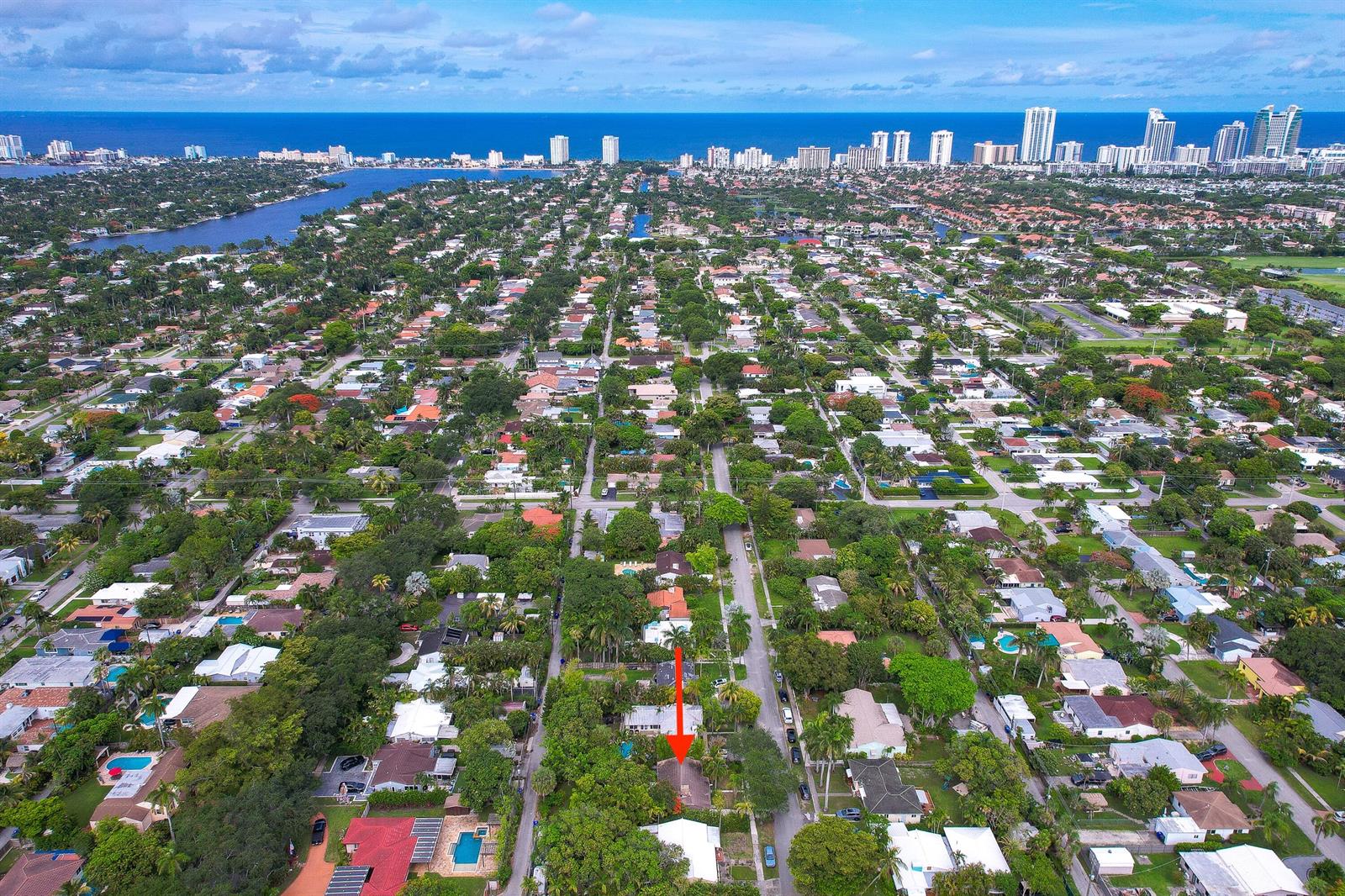 An aerial view of a residential neighborhood with a red arrow pointing to a house — 1535 Dewey Street, Hollywood FL 33020, HOLLYWOOD, FL