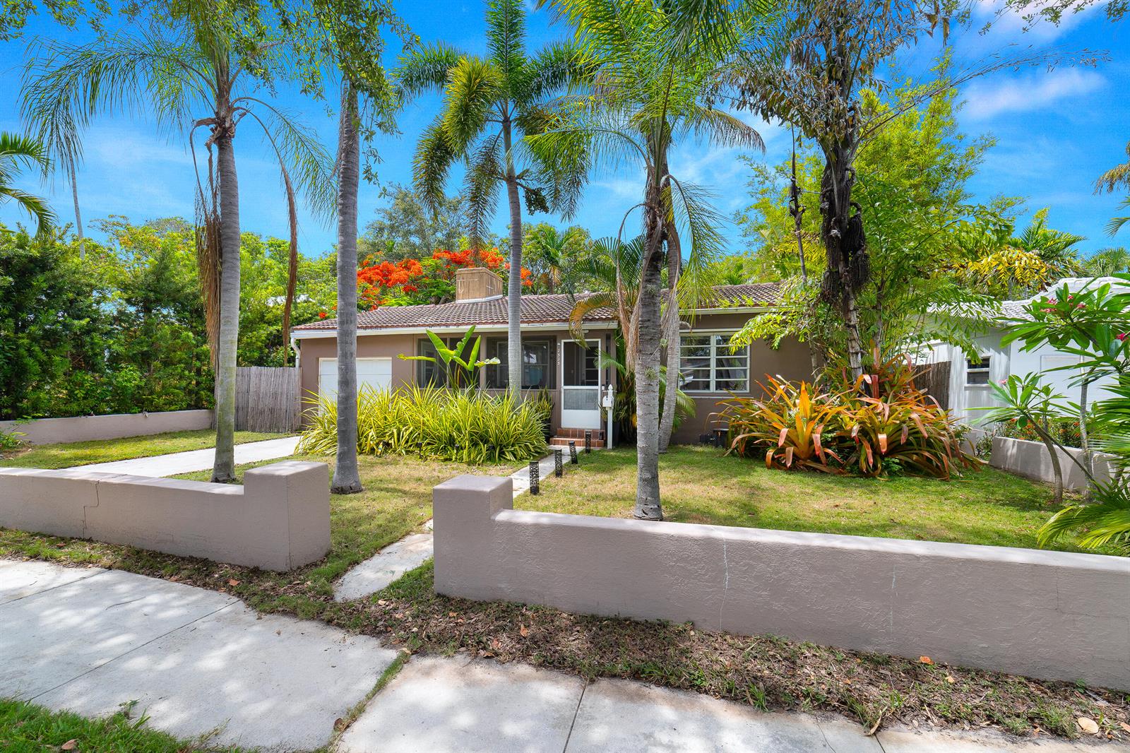 A single-story house with a brown exterior, palm trees, and a low concrete wall — 1535 Dewey Street, Hollywood FL 33020, HOLLYWOOD, FL