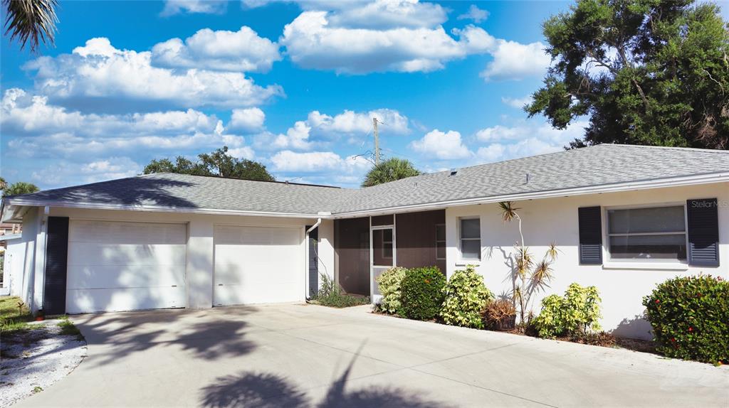 A single-story house with a two-car garage, a screened entryway, and a concrete driveway — 2118 MICHELE DRIVE, SARASOTA, FL