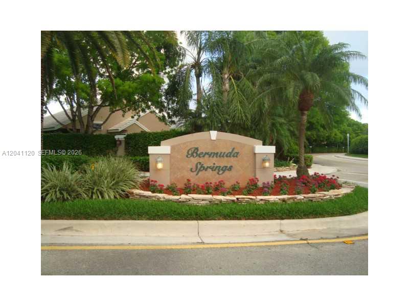 A stone monument sign for Bermuda Springs sits in a landscaped garden bed — 286 Bridgeton Way, Weston FL 33326, WESTON, FL