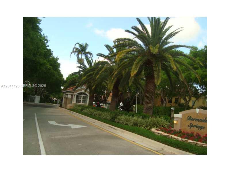 A paved road leads to the gated entrance of a community named Bermuda Springs — 286 Bridgeton Way, Weston FL 33326, WESTON, FL