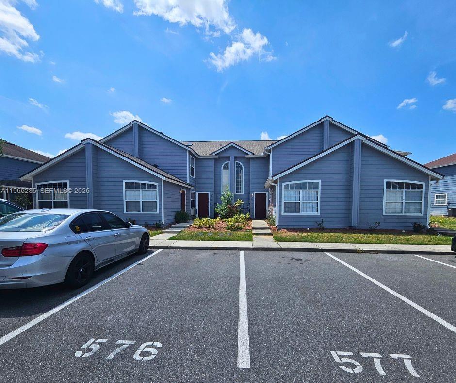 A two-story blue residential building with two front entrances and a parking lot — 515 ORCHID DR, Davenport FL 33897, DAVENPORT, FL