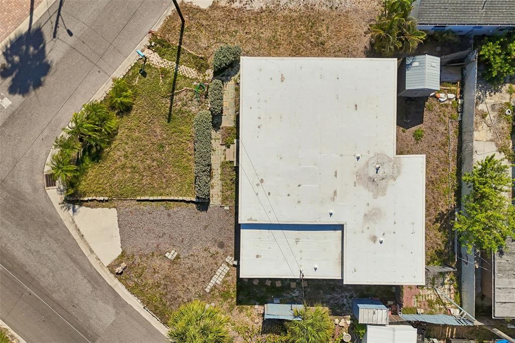 An aerial view shows a house with a flat roof, a yard, and a driveway — 13098 BOCA CIEGA AVENUE, MADEIRA BEACH, FL