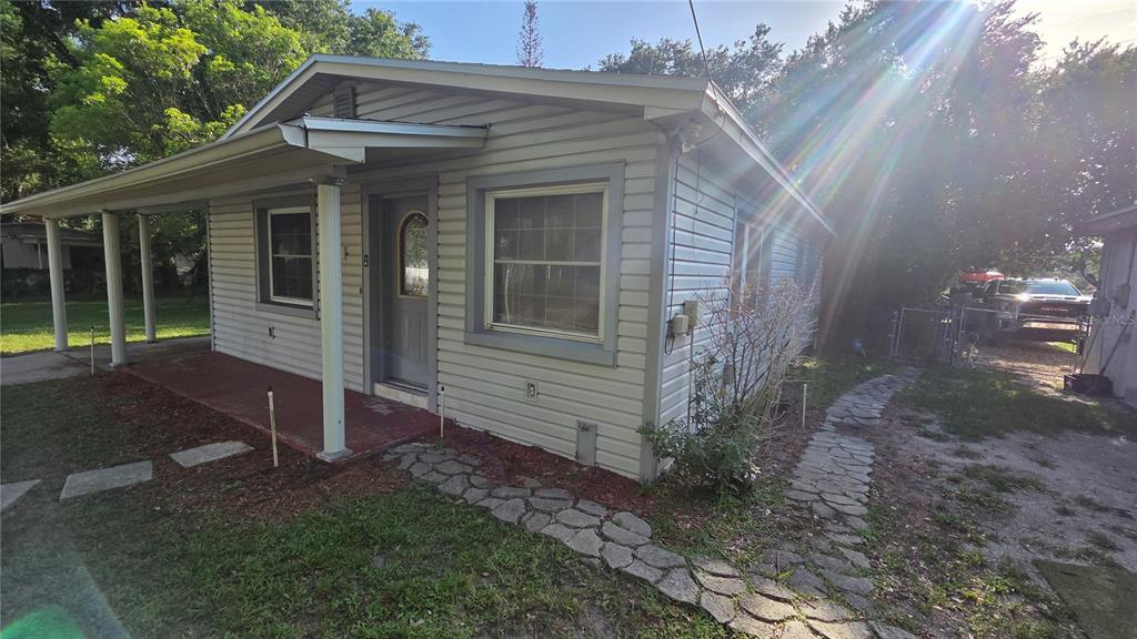 A light-colored, single-story house with a covered front porch and a stone walkway — 1636 TERRY ROAD, LAKELAND, FL