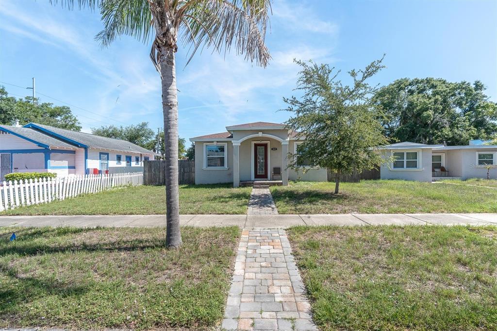 A single-story house with a paved walkway, a palm tree, and a white picket fence — 3069 19TH AVENUE S, ST PETERSBURG, FL
