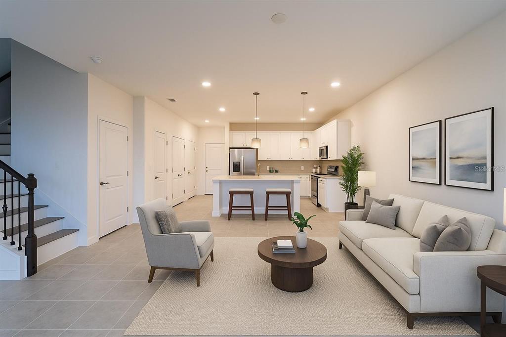 This is a rendering of an open-concept living room and kitchen with white cabinetry — 4887 CROSS PRAIRIE PARKWAY, ST CLOUD, FL