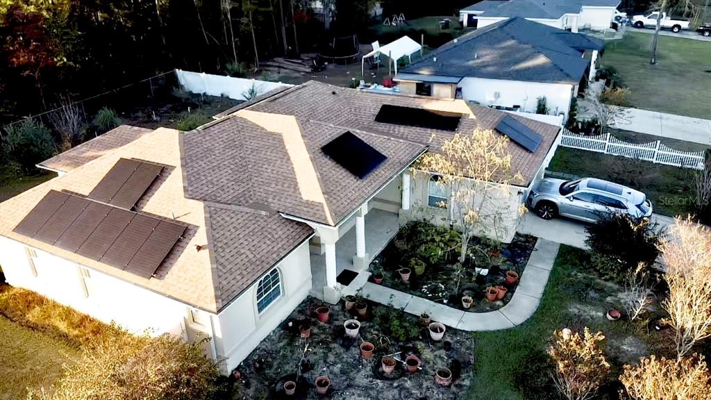 An aerial view of a house with solar panels on the roof and a front garden — 3715 SW 127TH LANE ROAD, OCALA, FL