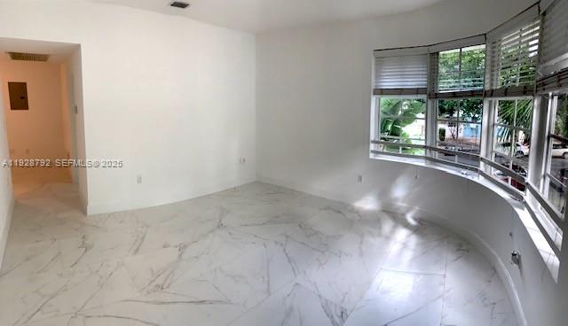 An empty room with white marble-patterned tile flooring and a large bay window — 1000 Meridian Ave # 23, Miami Beach FL 33139, MIAMI BEACH, FL