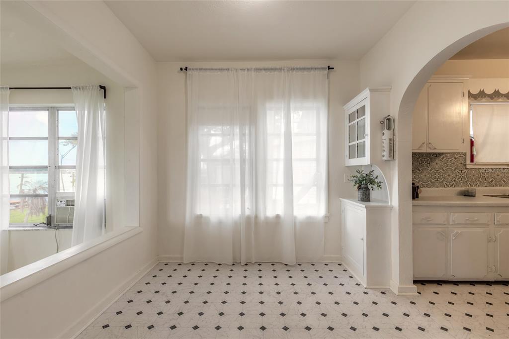 A dining area features white walls, sheer curtains, and a black-and-white patterned tile floor — 255 LEXINGTON DRIVE, DAYTONA BEACH, FL