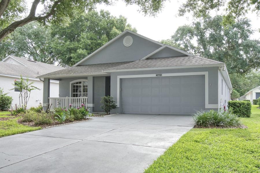 A gray single-story house with a two-car garage and a front porch — 3605 WESTERHAM DR, CLERMONT, FL