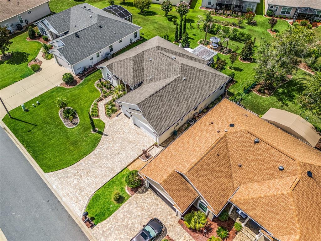 An aerial view shows two adjacent suburban houses with paved driveways and landscaped lawns — 11860 SE 179TH STREET, SUMMERFIELD, FL