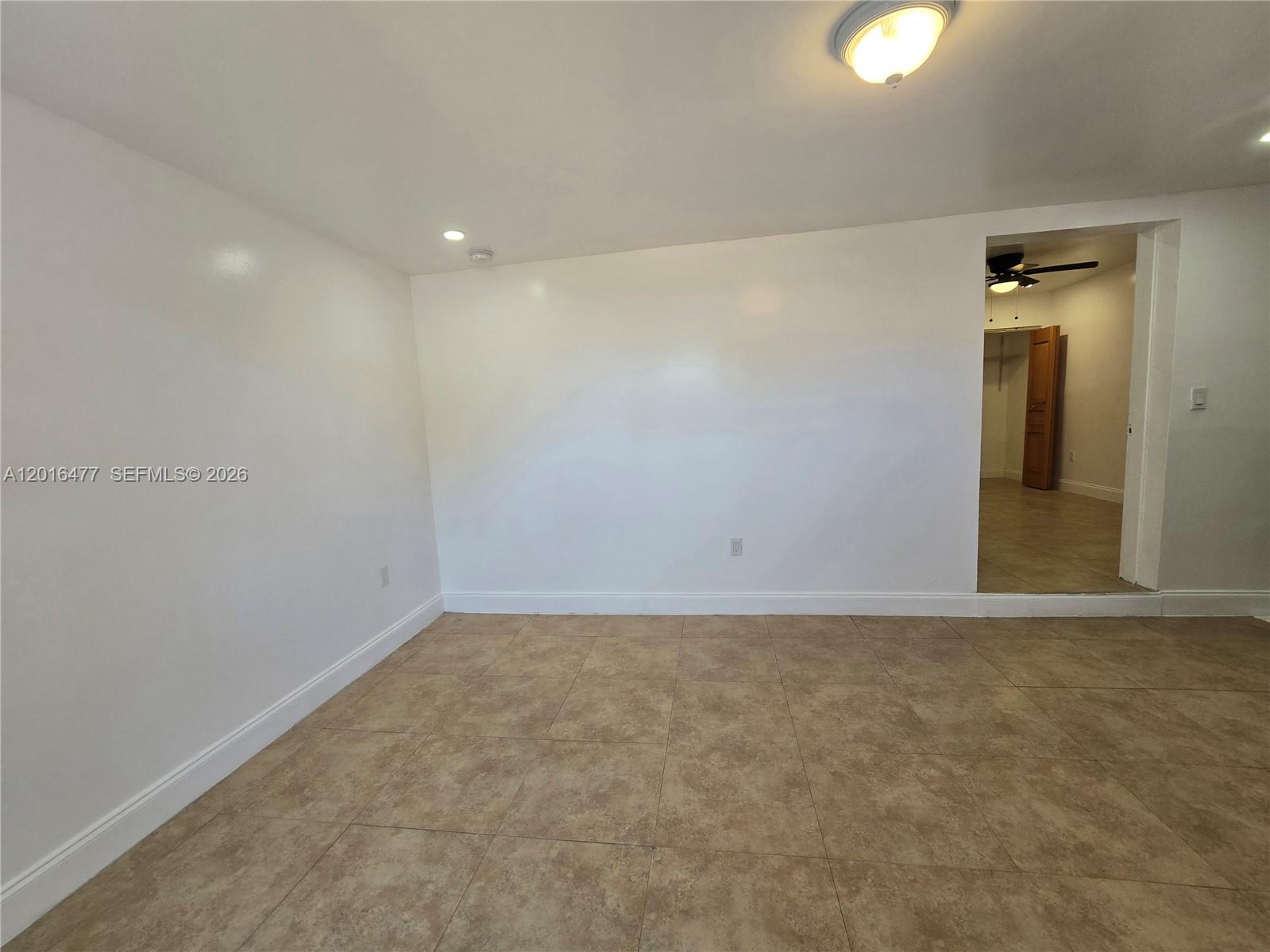 An empty room with white walls, tile flooring, and a doorway leading to a closet — 2957 SW 36th Ct # 4, Miami FL 33133, MIAMI, FL