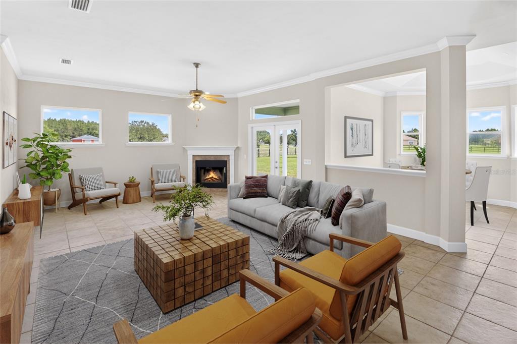 A living room with a fireplace, gray sofa, two orange chairs, and tile flooring — 10064 SW 98TH LANE, GAINESVILLE, FL