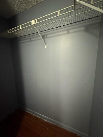 A small closet with dark gray walls, wood flooring, and a white wire shelf — 4384 NW 9th Avenue # 2f, Pompano Beach FL 33064, POMPANO BEACH, FL
