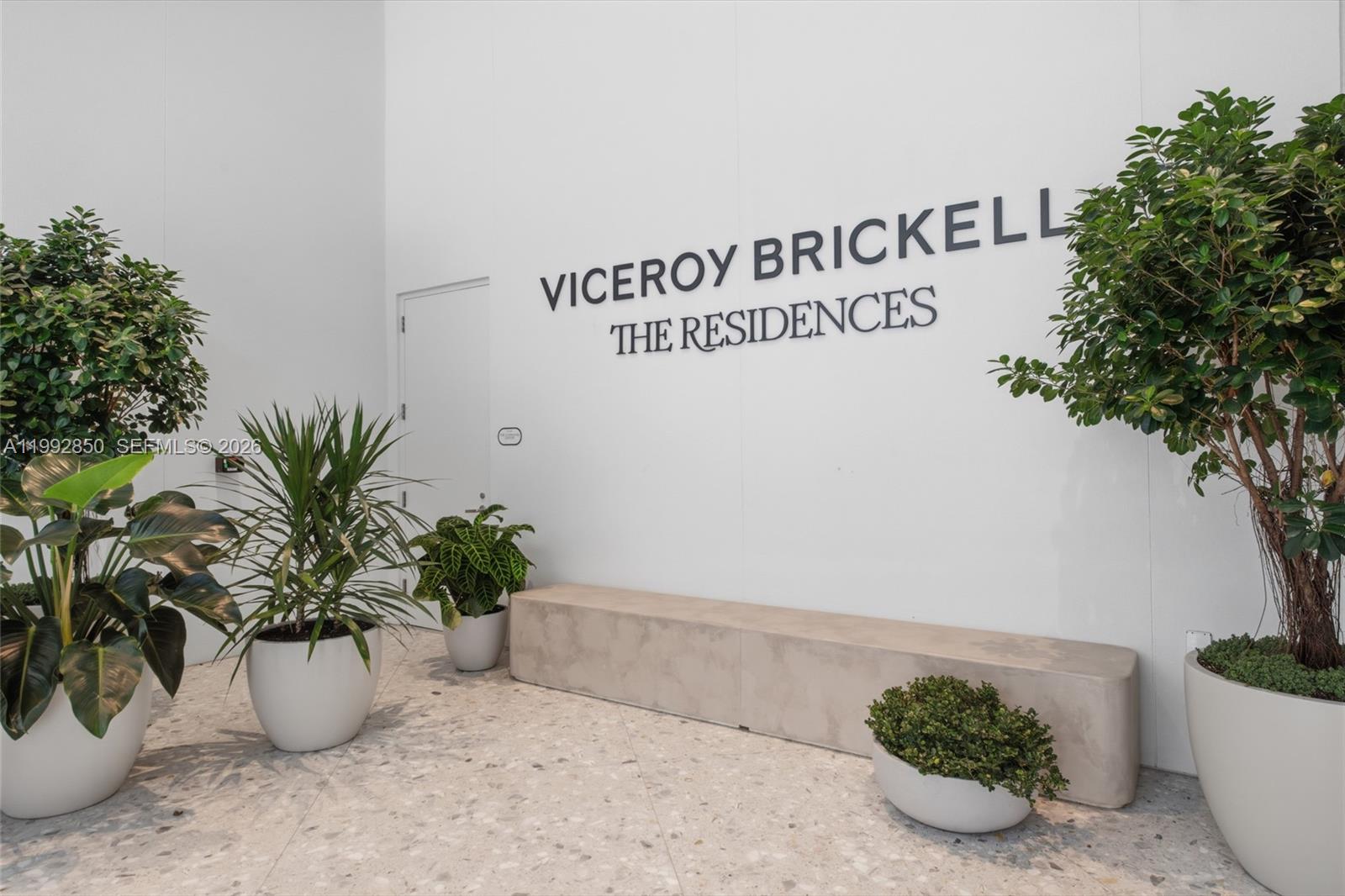 A white wall features the text Viceroy Brickell The Residences above a concrete bench and plants — 77 SE 5th Street # 2914, Miami FL 33131, MIAMI, FL