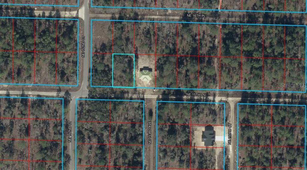 This aerial map shows residential lots with two houses and surrounding wooded areas — TBD NE 15TH LANE, WILLISTON, FL