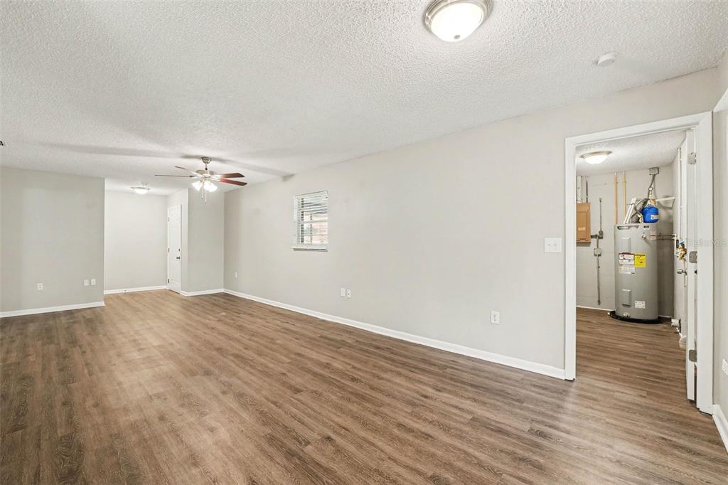 An empty room with wood-look flooring, a ceiling fan, and an open utility closet — 2047 SOMERVILLE DRIVE N, LAKELAND, FL