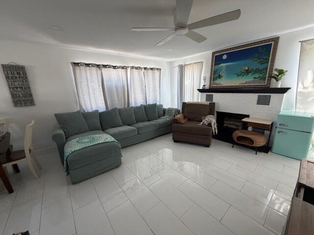 A living room features a blue sectional sofa, a fireplace, and white tile flooring — 1015 S K Street, FL 33460, FL
