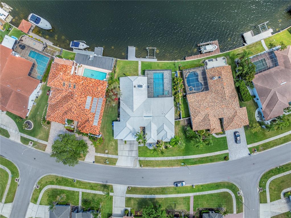 Aerial view of three waterfront houses with swimming pools and private boat docks — 5104 E LONGBOAT BOULEVARD, TAMPA, FL