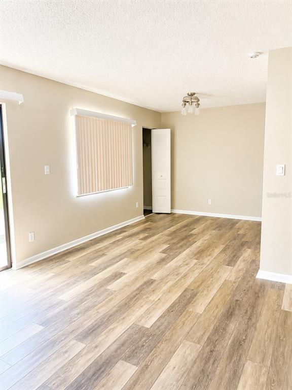 A living room features a sectional sofa, a coffee table, and an accent chair — 737 MIDWAY DRIVE UNIT A, OCALA, FL