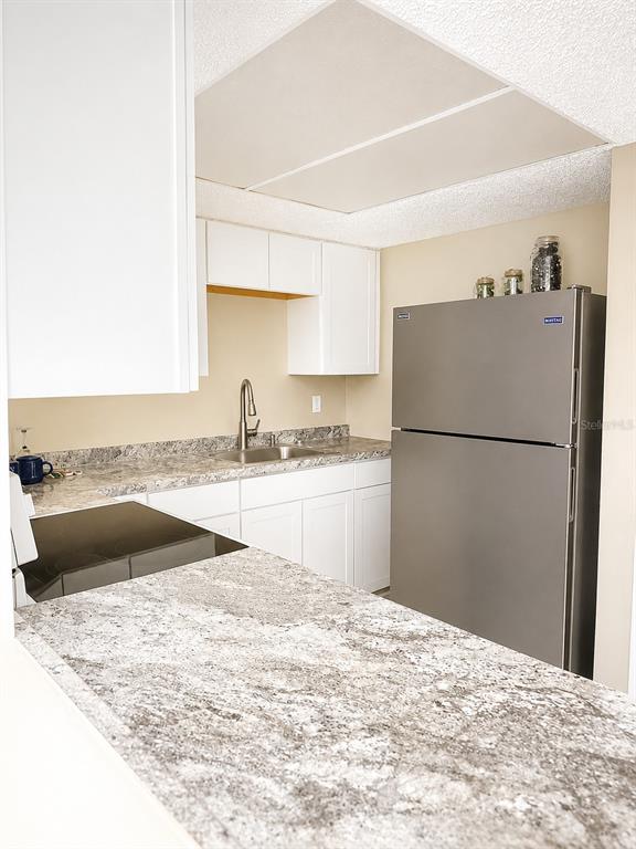 An empty room features light-colored walls, wood-look flooring, a ceiling light, and a closet — 737 MIDWAY DRIVE UNIT A, OCALA, FL