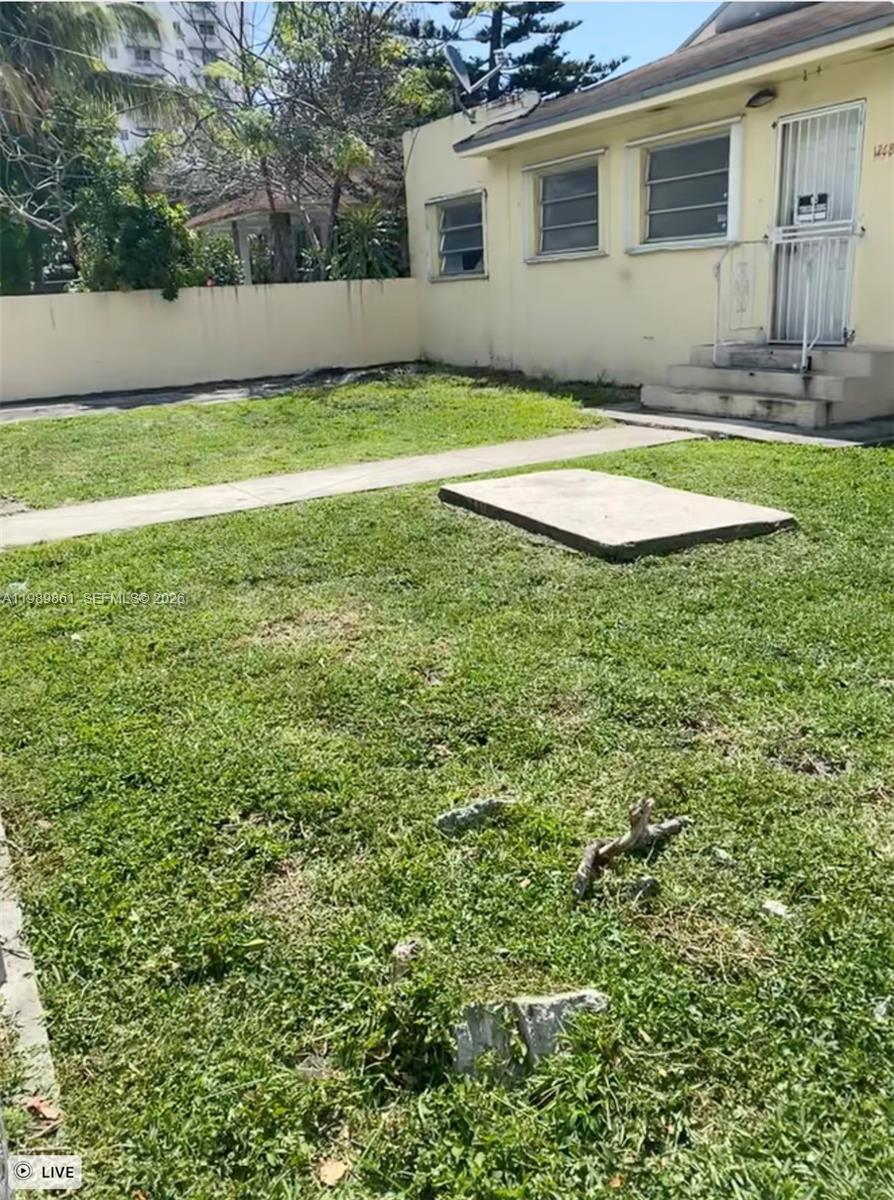 A yellow house exterior features a concrete walkway leading to a small front porch — 1268 SW 4th St, Miami FL 33135, MIAMI, FL