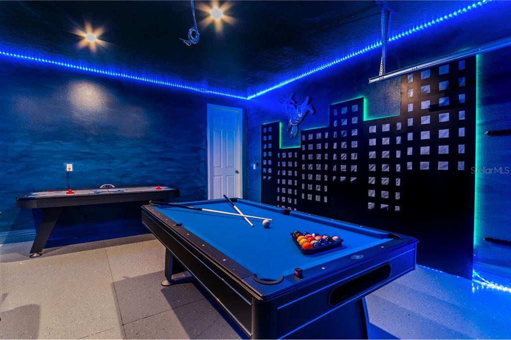 A game room features a pool table, air hockey table, and a Batman-themed wall mural — 8951 HILTON RIDGE AVENUE, KISSIMMEE, FL