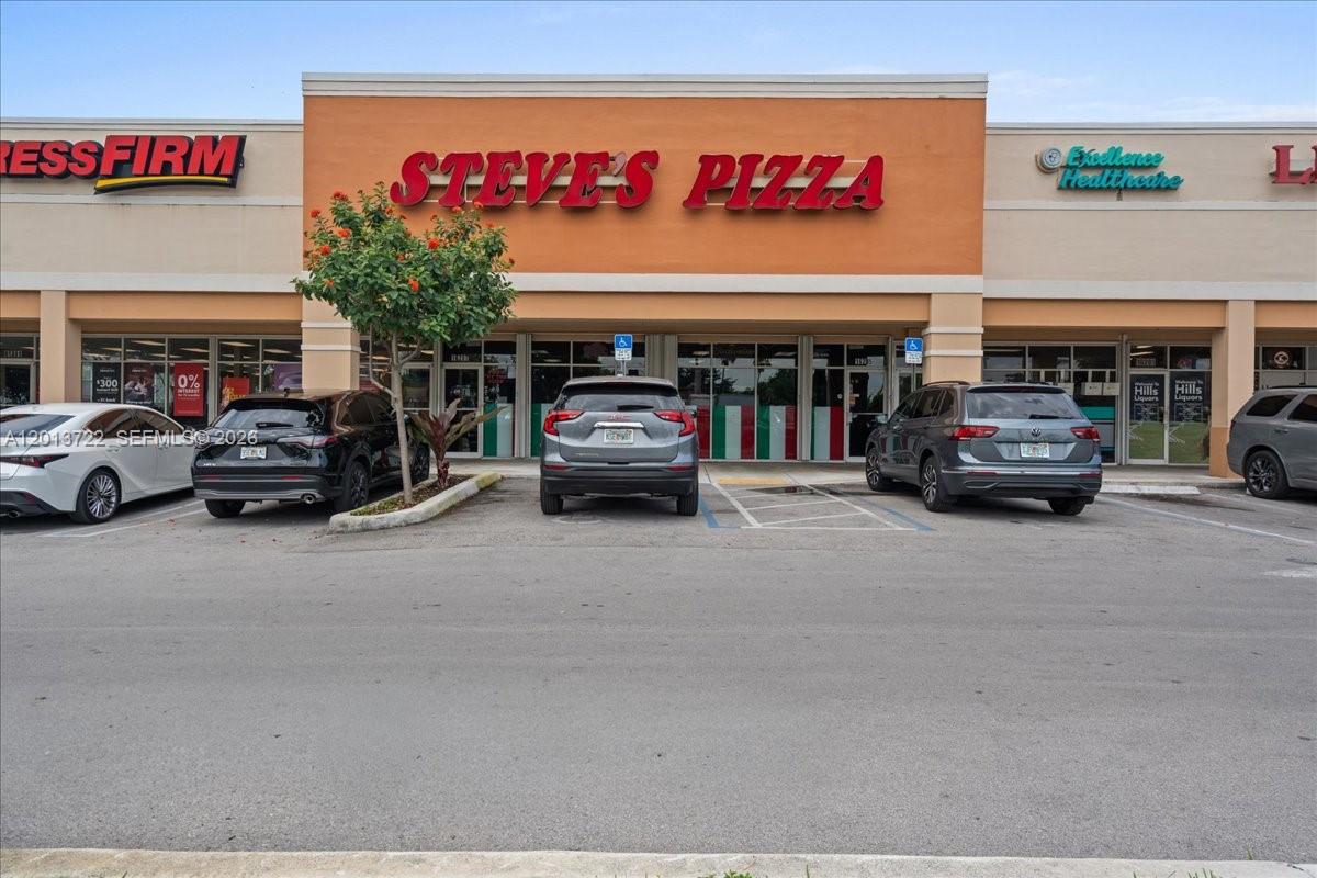 The exterior of a commercial strip mall features a Steve's Pizza restaurant with parked cars — 16285 SW 88 ST, Kendall FL 33193, KENDALL, FL