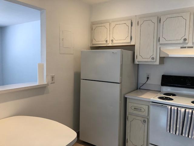 A kitchen features white cabinets, a white refrigerator, and a white stove — 370 Saxony Trail, Delray Beach FL 33446, DELRAY BEACH, FL
