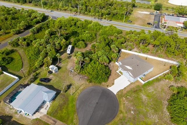 An aerial view shows two houses, a camper, and a cul-de-sac surrounded by dense vegetation — 3470 ETHLYN LANE, ROTONDA WEST, FL