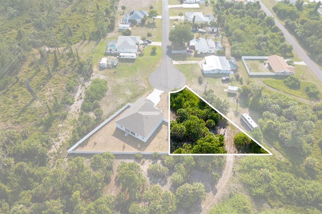 An aerial view shows a house with a fenced yard and an adjacent wooded lot — 3470 ETHLYN LANE, ROTONDA WEST, FL