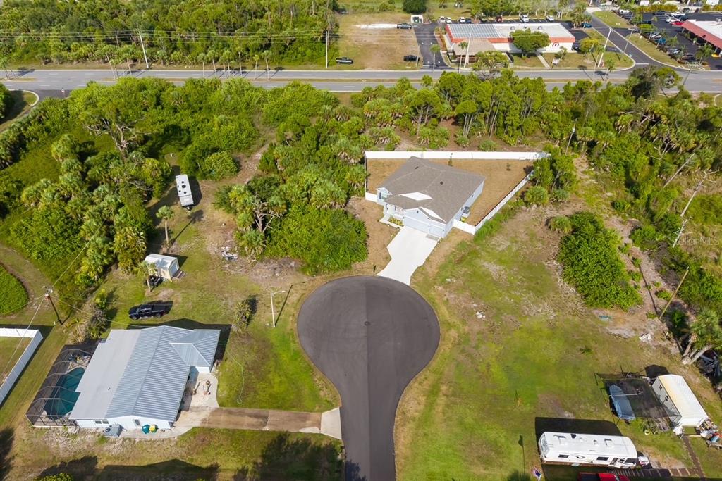 An aerial view shows a residential cul-de-sac with two houses, surrounding vegetation, and parked vehicles — 3470 ETHLYN LANE, ROTONDA WEST, FL