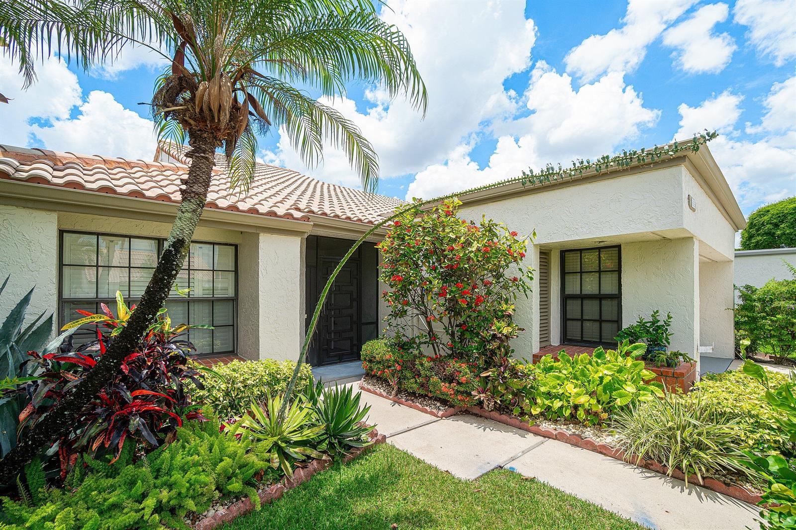 A single-story house with a tiled roof, palm tree, and landscaped front yard — 5635 Kiowa Circle, Boynton Beach FL 33437, BOYNTON BEACH, FL