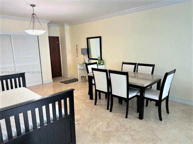 A dining area with a stone-topped table and six chairs sits near a bedroom set — 4001 S Ocean Dr # 9L, Hollywood FL 33019, HOLLYWOOD, FL