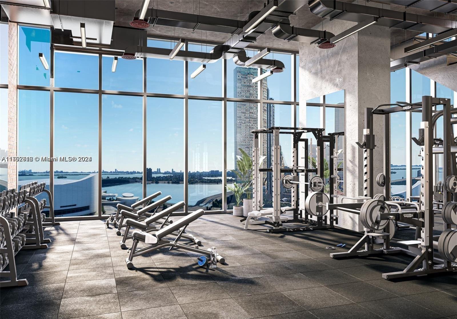 This rendering shows a modern gym with weight equipment, concrete ceilings, and floor-to-ceiling windows — 398 NE 5th St # 3010, Miami FL 33132, MIAMI, FL