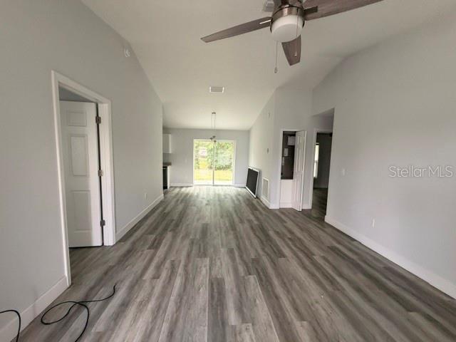 An interior view shows a room with light gray walls, wood-look flooring, and a ceiling fan — 3226 SW 152ND COURT, OCALA, FL