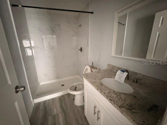 A bathroom features a walk-in shower with marble-look tile, a toilet, and a granite vanity — 3226 SW 152ND COURT, OCALA, FL