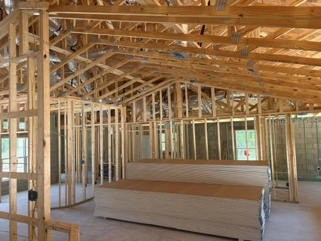 An interior view of a house under construction showing exposed wooden framing and stacked drywall — 12188 SW 81ST STREET, DUNNELLON, FL