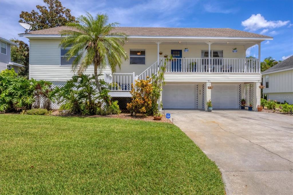 A two-story house with white siding, a front porch, and a two-car garage — 1408 43RD AVENUE DRIVE W, PALMETTO, FL