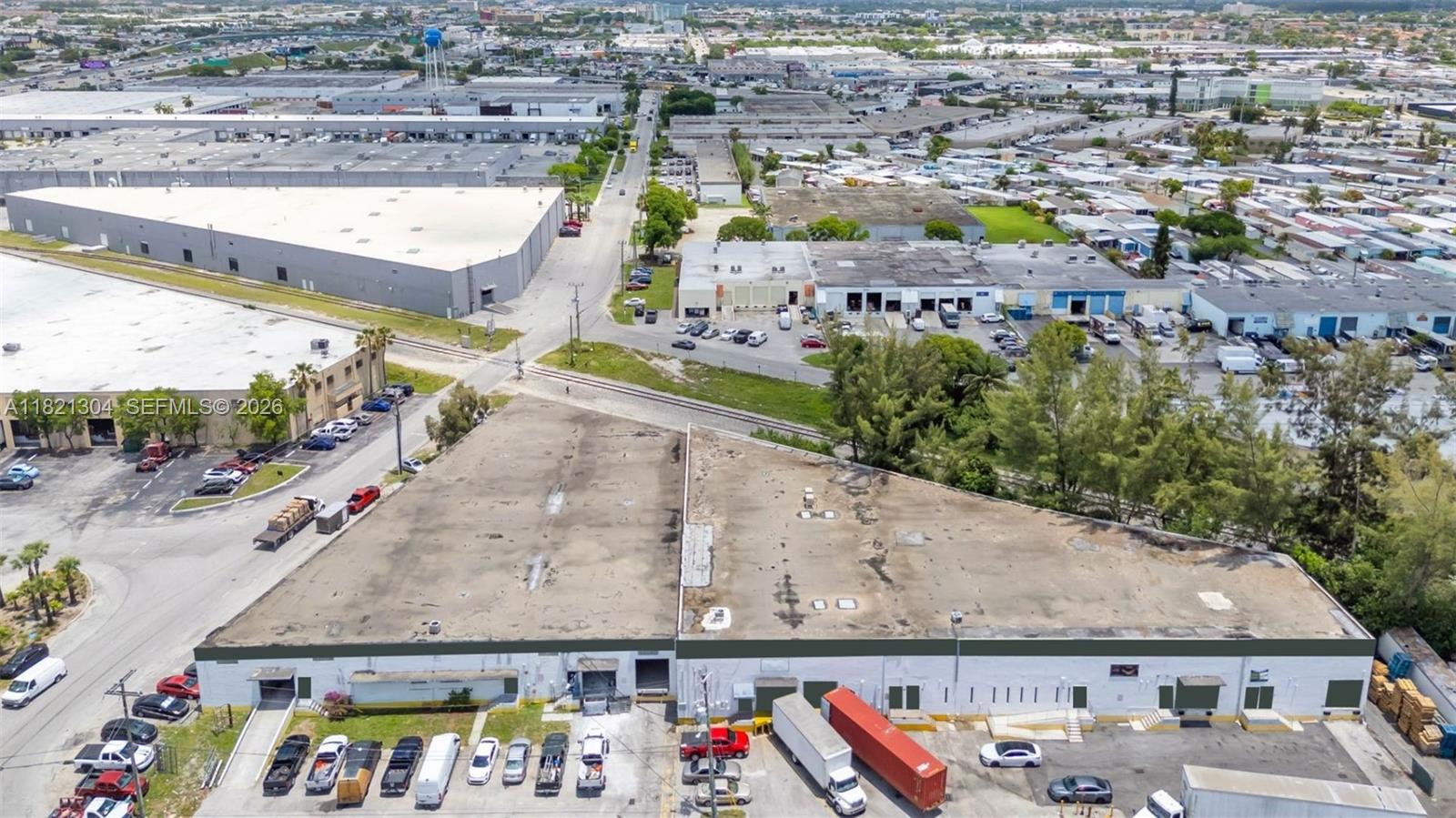 An aerial view shows two adjacent industrial warehouse buildings with parking lots and loading docks — 7361 NW 78th St, Medley FL 33166, MEDLEY, FL