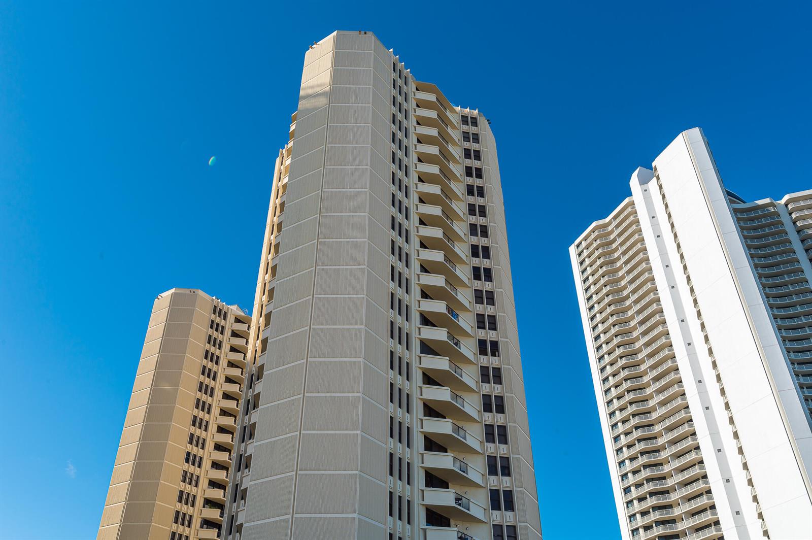 Three tall residential high-rise buildings stand against a clear blue sky — 2800 N Ocean Drive # 2b, Singer Island FL 33404, SINGER ISLAND, FL