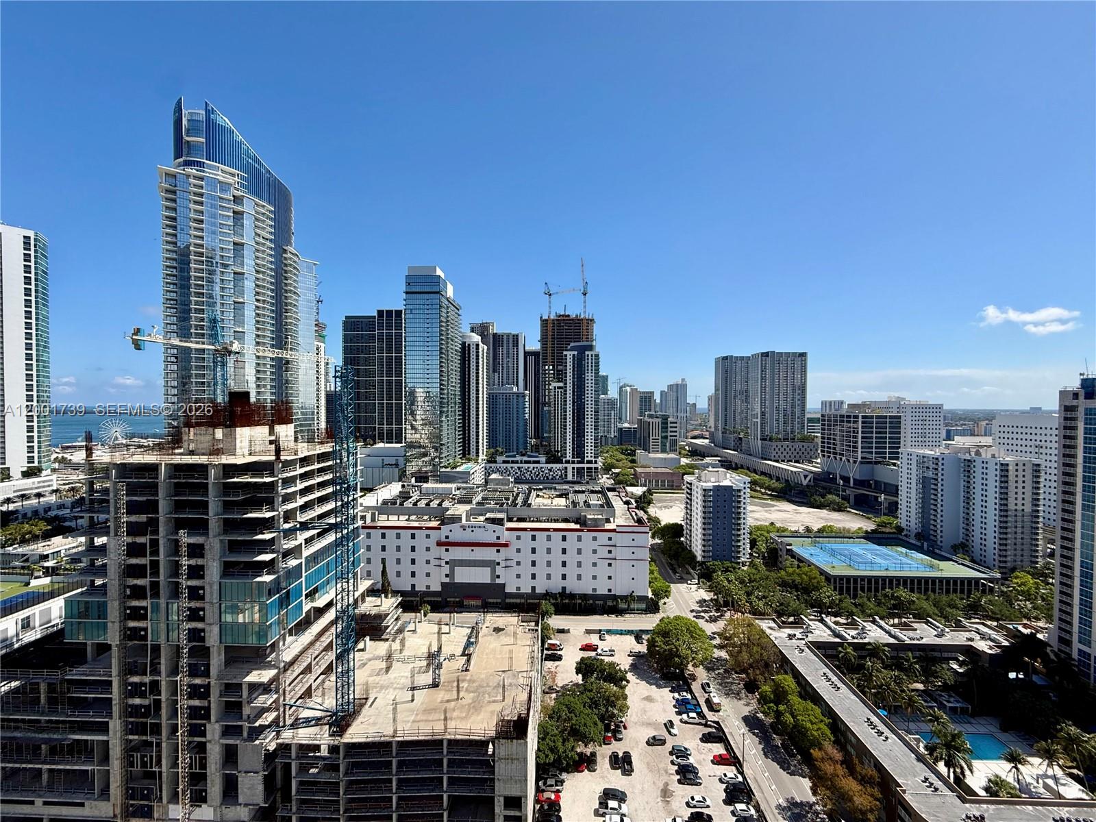 An elevated view of a city skyline featuring several skyscrapers, construction sites, and parking lots — 20 NE 11th St # 2809, Miami FL 33132, MIAMI, FL