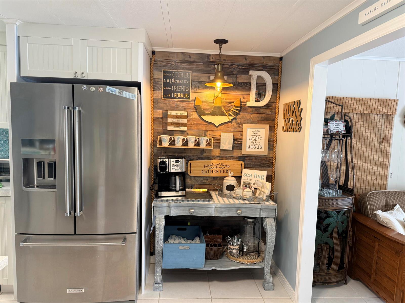 A coffee station with a wood-paneled accent wall, nautical decor, and a vintage-style console table — 225 W 2nd Court, Key Largo FL 33037, KEY LARGO, FL