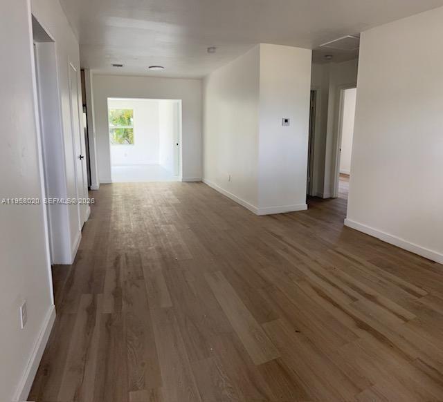 An interior view of a room with light wood-look flooring and white walls — 3840 NE 12th Ave, Pompano Beach FL 33064, POMPANO BEACH, FL