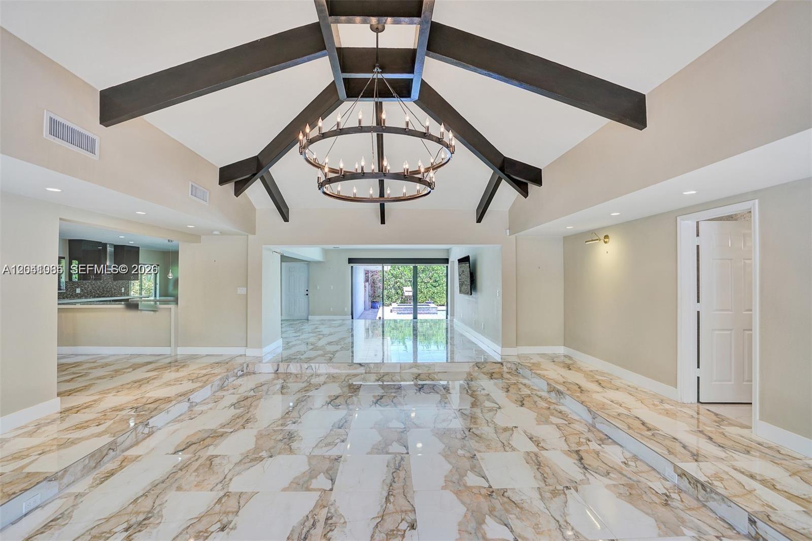 A sunken living room features a vaulted ceiling with dark beams and marble flooring — 2255 NE 120th St, North Miami FL 33181, NORTH MIAMI, FL